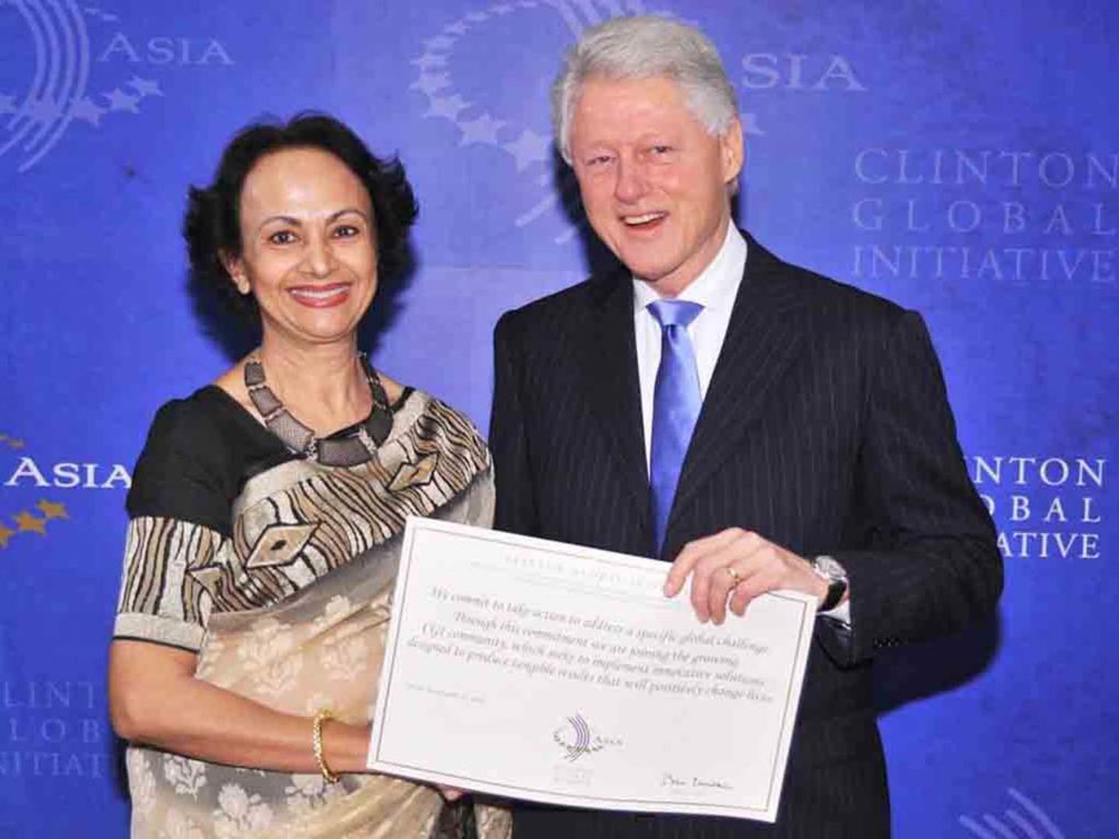 Clinton Global Initiative Award at the hands of President Bill Clinton